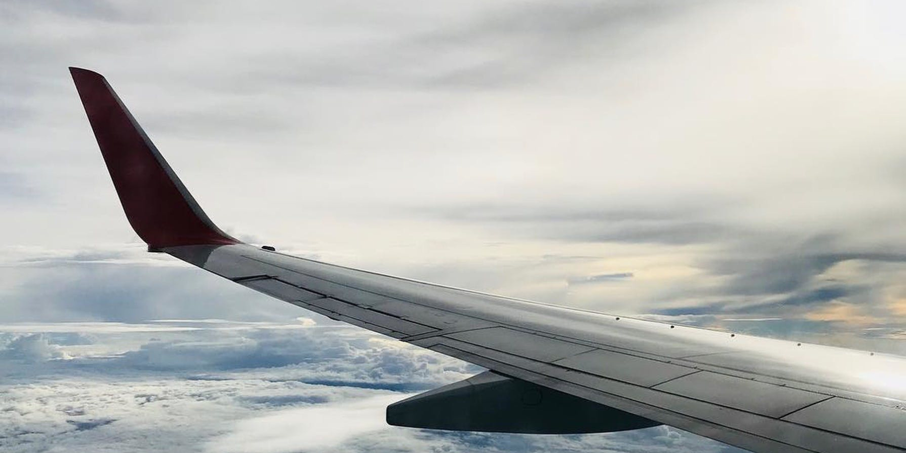 Image of an aircraft wing above the clouds