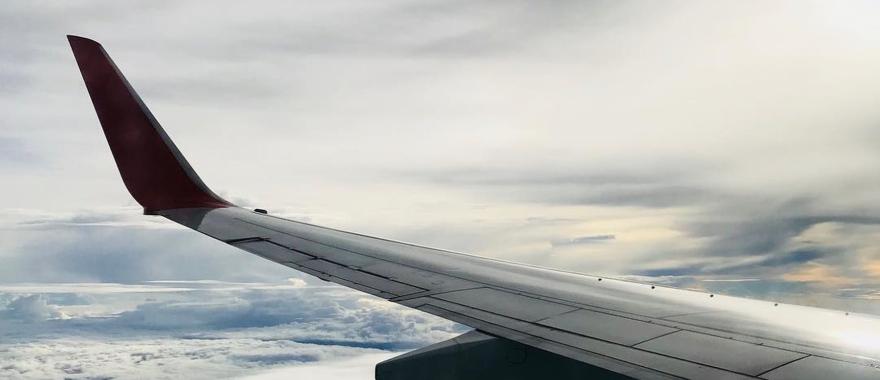 Image of an aircraft wing above the clouds