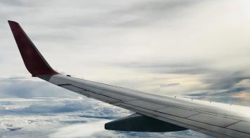 Image of an aircraft wing above the clouds