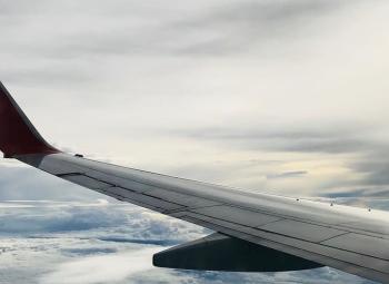 Image of an aircraft wing above the clouds